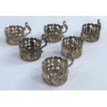 A set of 6 silver coffee can holders with extensive pierced and embossed decoration, Sheffield 1906