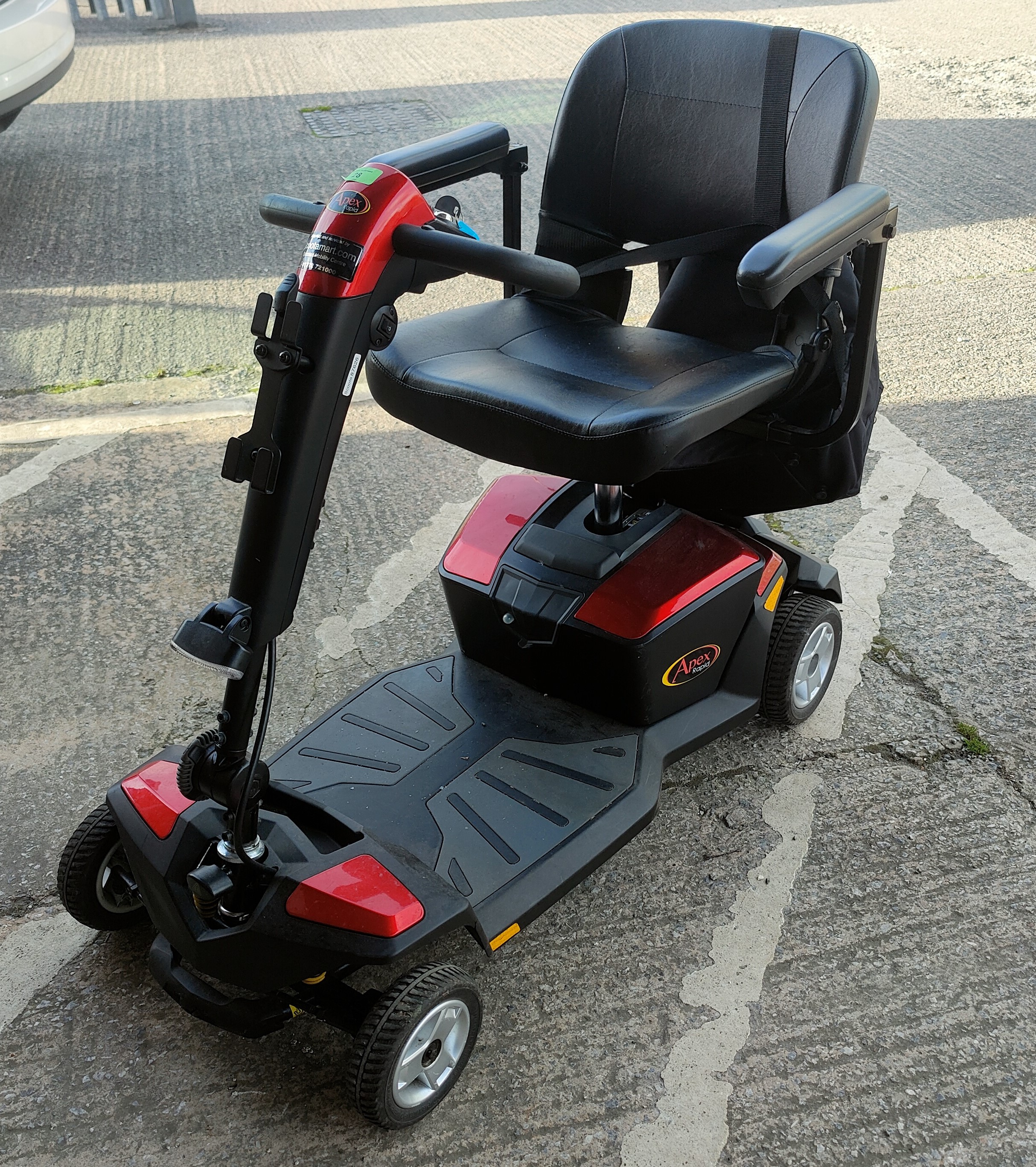 An 'Apex Rapid' mobility scooter with paperwork