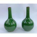 A pair of Chinese monochrome green crackle glaze bottle vases, with slender necks and bulbous