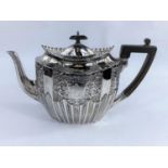 An oval victorian hallmarked silver teapot with extensive embossed gadrooned decoration,