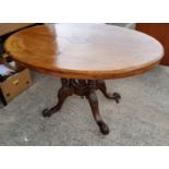 A Victorian inlaid oval centre table with four columns supports Length 120cm