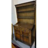 A reproduction carved oak Welsh dresser