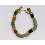 A yellow metal bracelet set with multicloured stones, unmarked (tests as circa 18ct.)