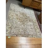 A large hand knotted rug with fawn ground 188 x 274cm