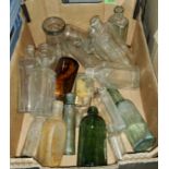A collection of various vintage small clear glass bottles
