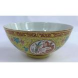 A Chinese yellow glaze bowl with four detailed circular polychrome panels depicting a pheonix and