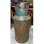 A vintage cast metal Manchester Co-op society milk churn converted into planter with vintage