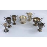 Five hall marked silver small trophy cups various dates and assay offices 7.9oz; a medal for