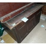 A oak panelled chest with hinged lid