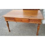 A Victorian style stripped pine kitchen table with tapered legs, carved decoration, single drawer