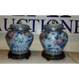 A near matching pair of Chinese cloisonne lidded vases with hard wood stands brass highlights