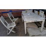 A rectangular slatted wood garden table and 6 folding chairs