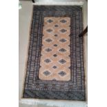 A modern fawn ground Persian style carpet 135cm x 76cm