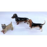 Three Beswick dogs, Dachshund 361, Cairn Terrier with ball 1055A and a Basset Hound 2045.