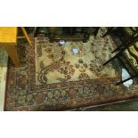 A large cream ground Persian style carpet with red leaf borders 204cm x 296cm