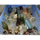 A collection of various vintage glass bottles of different colours