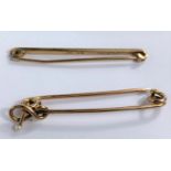A yellow metal plain bar brooch, stamped '9ct'; a yellow metal pearl set bar brooch, unmarked