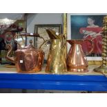A copper half gallon copper conical jug, another similar brass and a copper tea pot