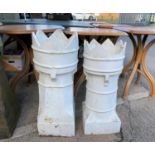 A pair of white chimney planters
