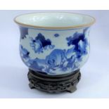 A Chinese blue and white spittoon on a hardwood stand, diameter 20cm (some wear to glaze