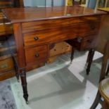 A Regency period mahogany kneehole dressing table with rising top, blind drawer front over 2 lower