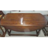 An "Old Charm" reproduction 2 tier coffee table with oval drop leaf top