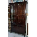 A stag display cabinet with double glazed doors above and double doors below height 181, width 95cm