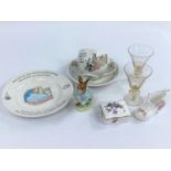 A small selection of Wedgewood Peter Rabbit items, a Beswick Peter Rabbit, two plates of