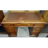 An Edwardian mahogany kneehole desk, inset top, 3 frieze, 6 pedestal drawers with brass handles
