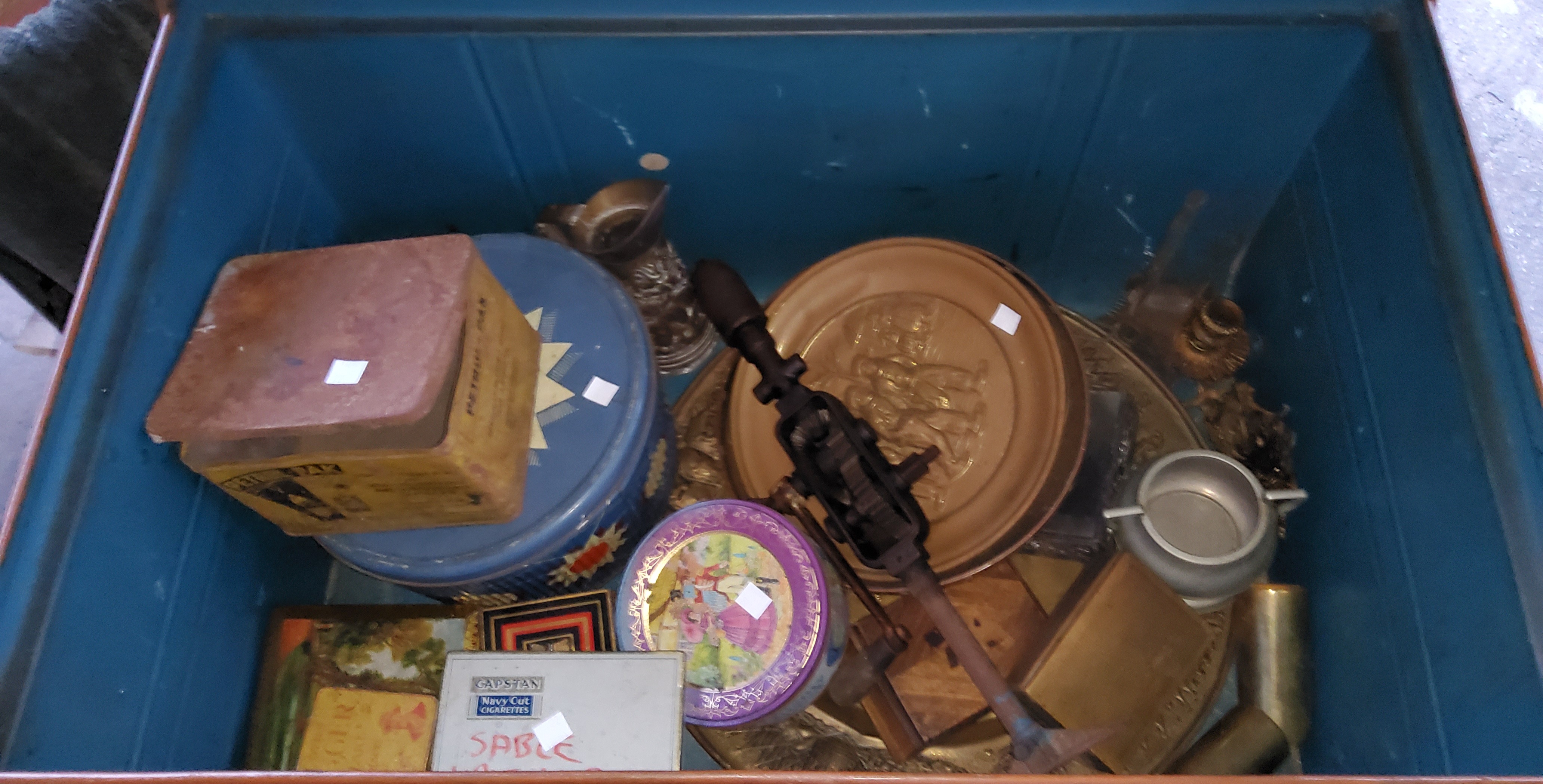A tin trunk and contents: old tins; metal wire and collectables