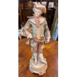 A bisque figure, young man in 18th century dress, in the style of Royal Worcester