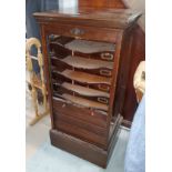 An early 20th century mahogany tambour front filing cabinet enclosing 7 sliding shelves