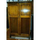 An early 20th century oak compactum style wardrobe with panelled doors, fitted right hand section