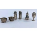 A hallmarked silver pair of salts of circular ribbed form on raised pedestal feet, Birmingham