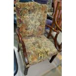 A traditional armchair in floral tapestry, and a similar rectangular stool.