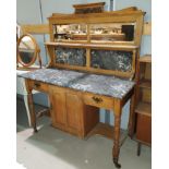 A stripped wood, marble top wash stand with tall mirror and marble splash back with marble top