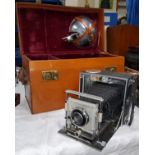 A vintage Universal Graflex style plate camera with a Syncro-Compur Ross lens, a fitted case with