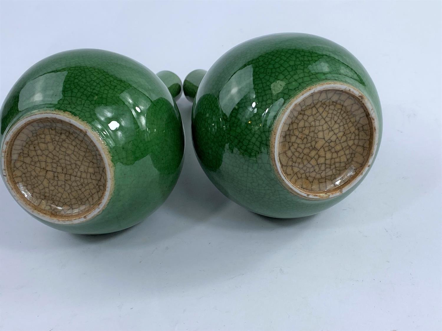 A pair of Chinese monochrome green crackle glaze bottle vases, with slender necks and bulbous - Image 3 of 4