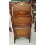 A mahogany magazine rack with single cupboard below