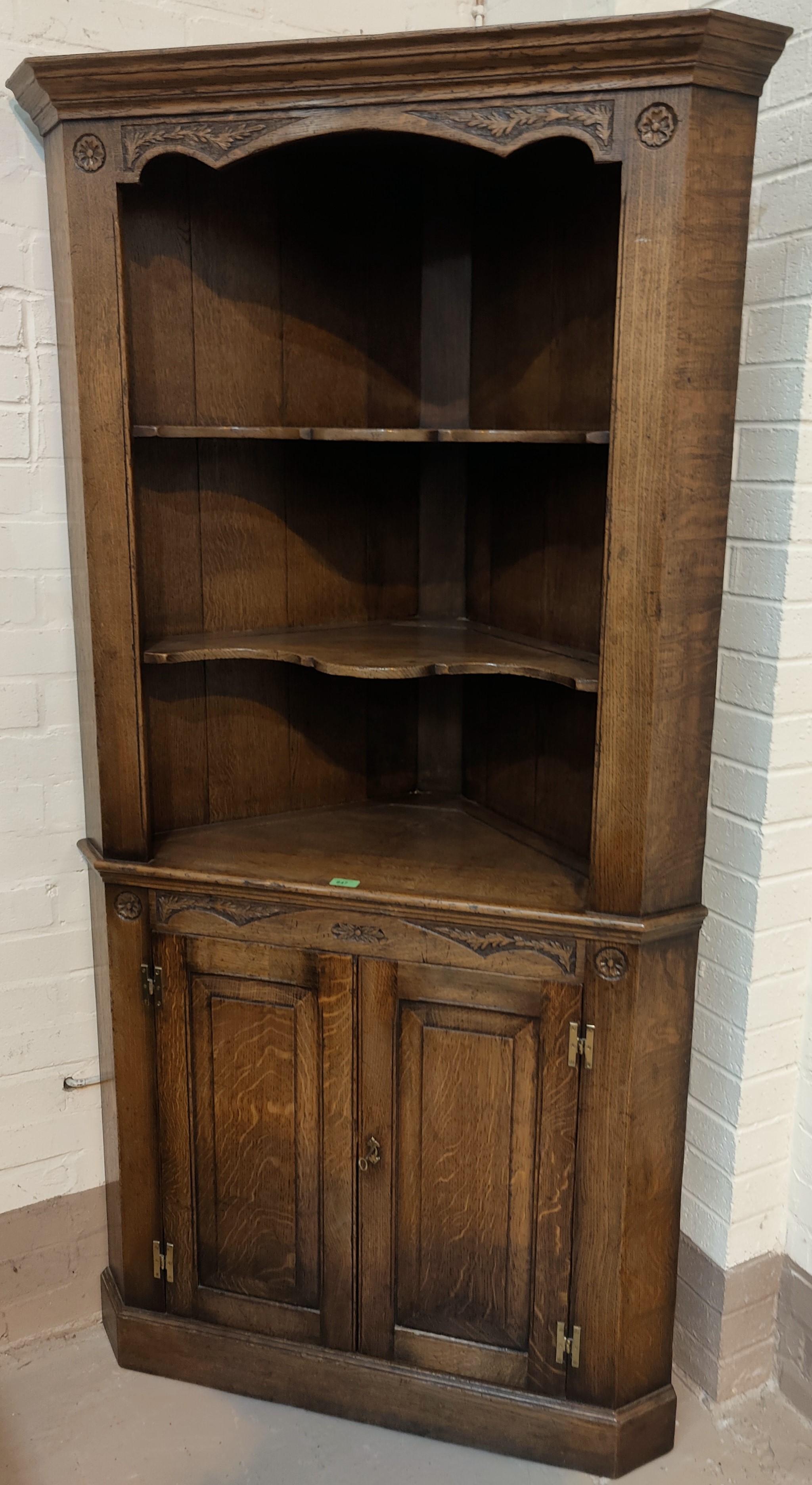 A 'Royal Oak' full height distressed oak corner cupboard with two shelves above and double