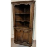 A 'Royal Oak' full height distressed oak corner cupboard with two shelves above and double