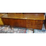 A mid 20th century teak Dalescraft long low sideboard with a rounded rectangular top, having four