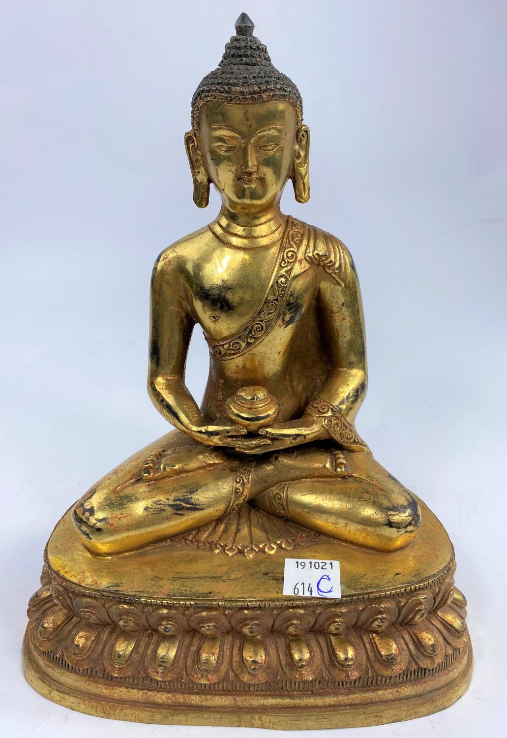 A Chinese bronze gilded figure of a buddha in lotus position, ht 23cm