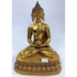 A Chinese bronze gilded figure of a buddha in lotus position, ht 23cm