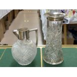 A hall marked silver collar and handled cut glass claret jug,and another