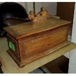 An Arts and Crafts box of bombe form, oak 20th century, with finial of 2 angels, 22cm