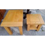 A modern light wood coffee table with square top and another similar