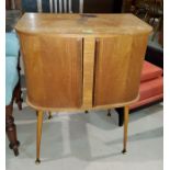 A 1960's oak veneered tambour front record cabinet, 60cm and a nest of 3 teak tables, 53cm