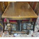 An oak dining table with rectangular draw leaf top on carved bulbous legs