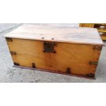 A large antique style solid top wooden chest with later metalwork with interior candle box